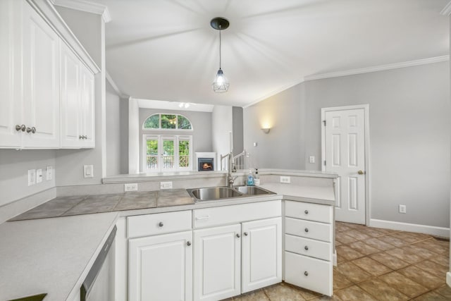 kitchen with sink, white cabinets, pendant lighting, and stainless steel dishwasher