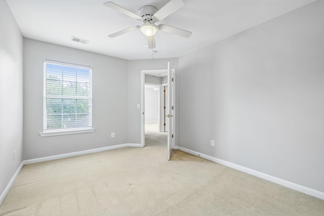 unfurnished bedroom featuring ceiling fan and light carpet