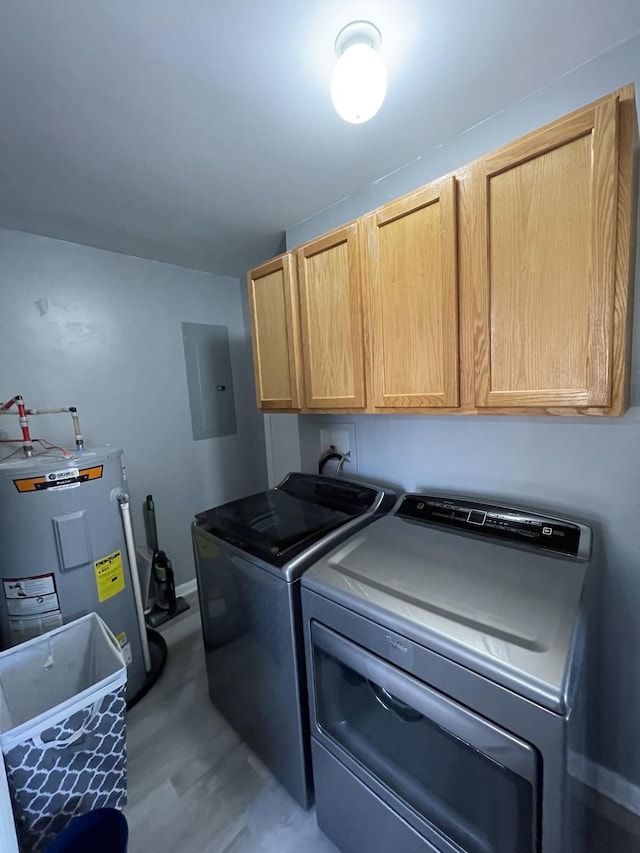 laundry room with washer and clothes dryer, cabinets, electric water heater, and electric panel