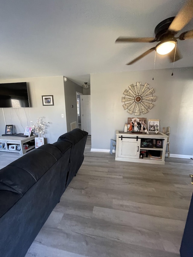 living room with hardwood / wood-style flooring and ceiling fan