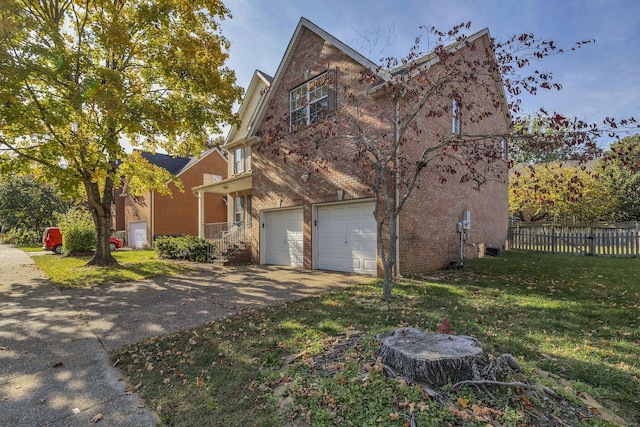 view of side of home with a garage and a yard