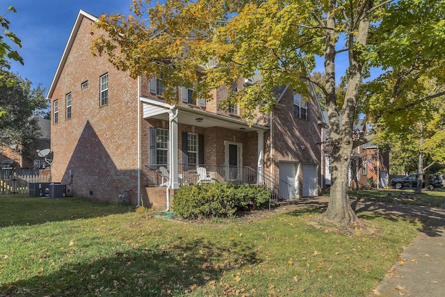 view of front of home featuring a garage, a front yard, and a porch