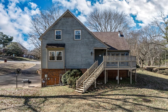 view of front of house featuring a front yard and a deck