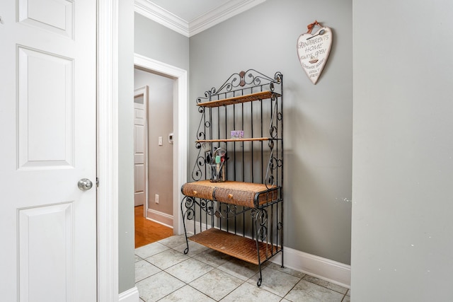 hall featuring ornamental molding and light tile patterned floors