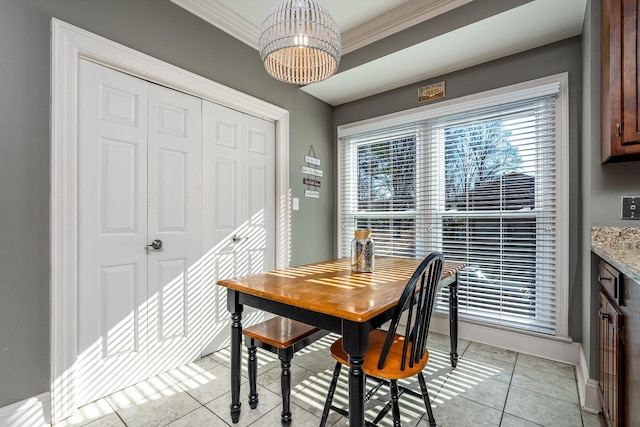 tiled dining room featuring crown molding and a notable chandelier