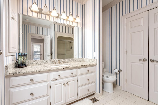 bathroom featuring vanity, tile patterned flooring, a shower with door, and toilet