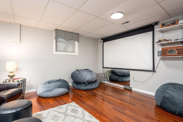 home theater with a paneled ceiling and wood-type flooring