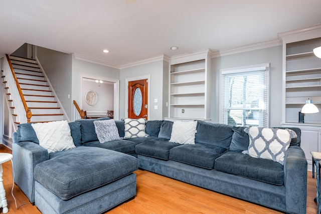 living room with crown molding, wood-type flooring, and built in features