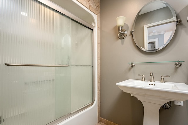 bathroom with enclosed tub / shower combo and sink