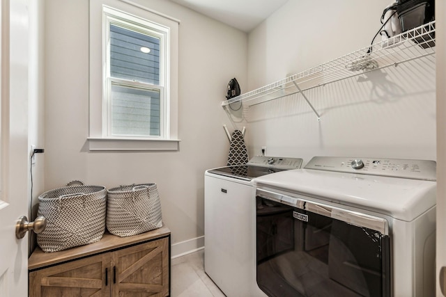 washroom featuring light tile patterned floors and washer and dryer