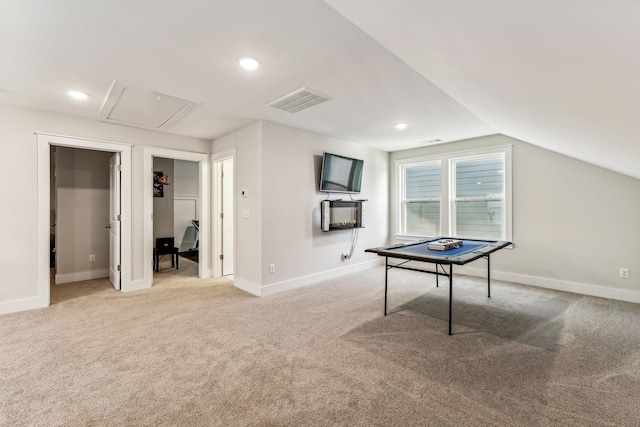 rec room with light colored carpet and vaulted ceiling