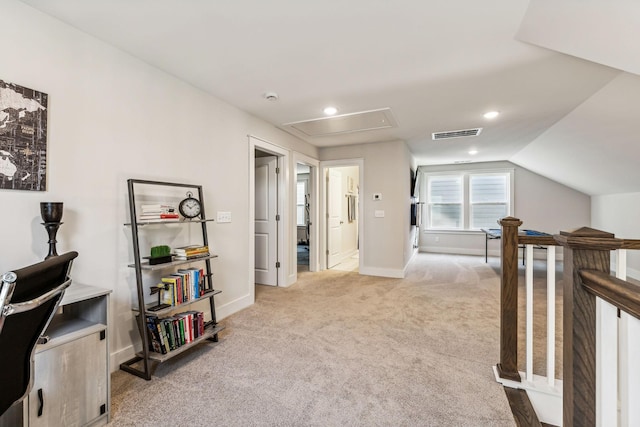 corridor with light colored carpet and vaulted ceiling