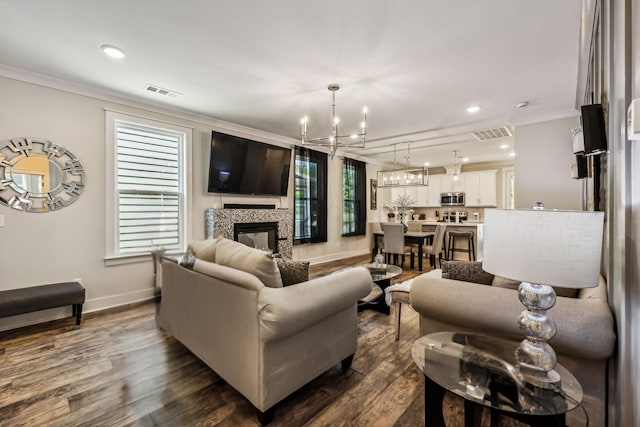 living room featuring a fireplace, a healthy amount of sunlight, and dark hardwood / wood-style floors