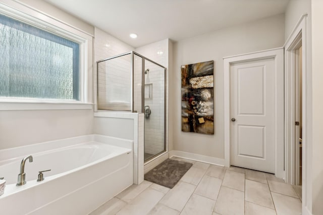 bathroom with tile patterned floors and separate shower and tub