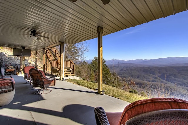 view of patio with a mountain view and ceiling fan