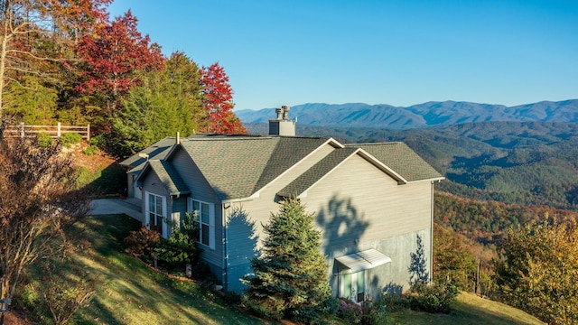 exterior space featuring a yard and a mountain view