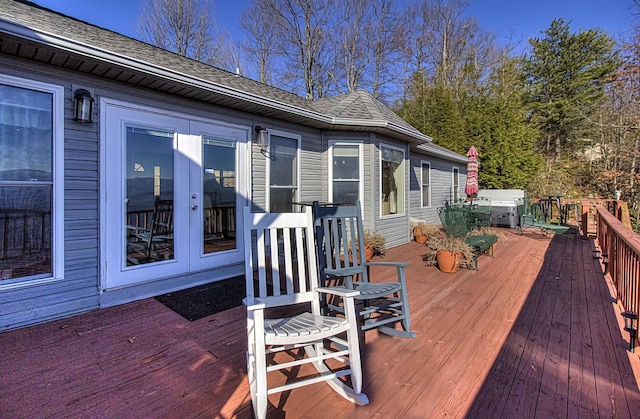 deck with a jacuzzi and french doors