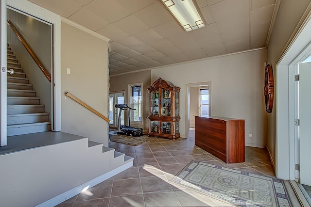 stairs featuring tile patterned flooring and crown molding