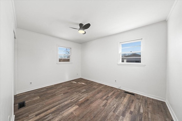 unfurnished room featuring ceiling fan, dark hardwood / wood-style flooring, and crown molding