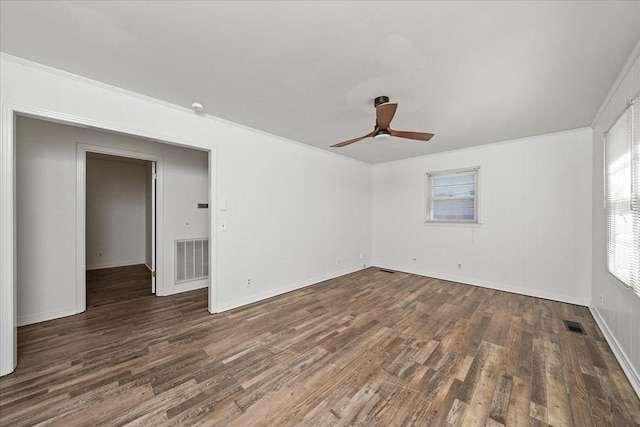 spare room with dark wood-type flooring and ceiling fan