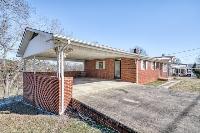 view of side of property featuring a carport