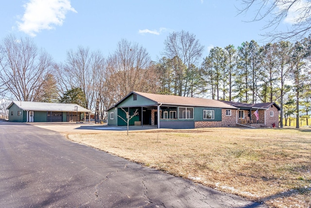 ranch-style house featuring a front yard and a carport