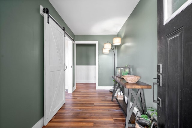 hall with dark hardwood / wood-style floors and a barn door