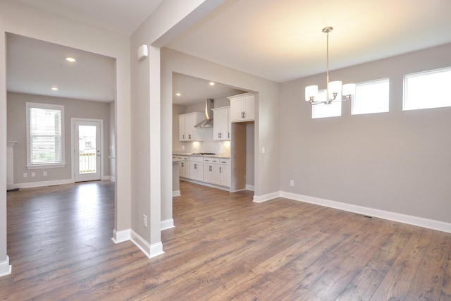 interior space with a chandelier and dark hardwood / wood-style floors