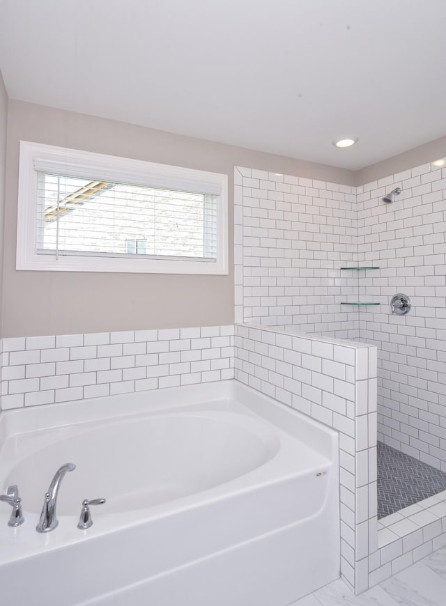 bathroom with shower with separate bathtub