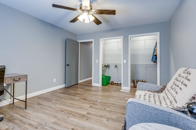 sitting room featuring wood-type flooring and ceiling fan