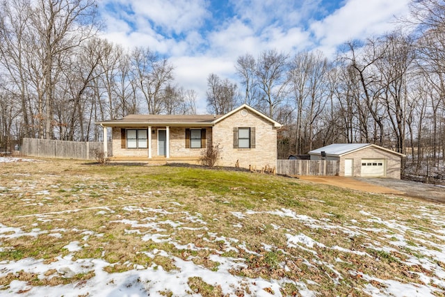 single story home featuring a garage, an outbuilding, and a yard