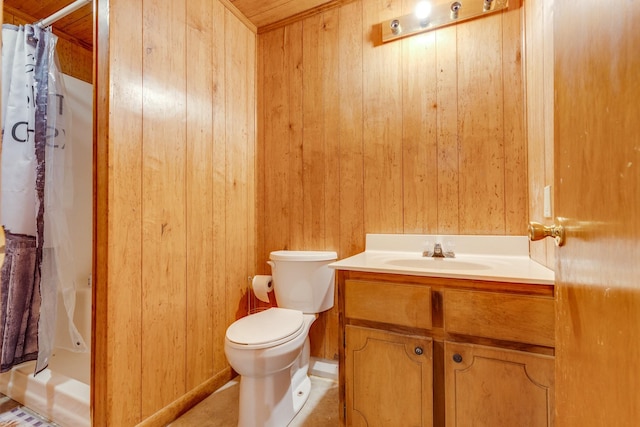 bathroom featuring curtained shower, toilet, vanity, and wooden walls