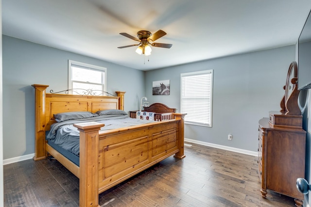 bedroom featuring ceiling fan, dark hardwood / wood-style flooring, and multiple windows