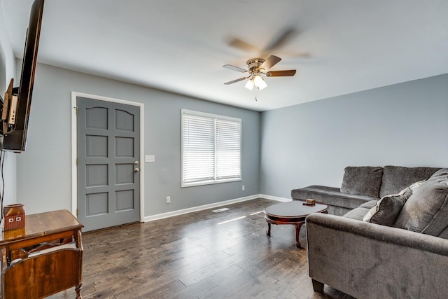 living room featuring dark hardwood / wood-style floors and ceiling fan