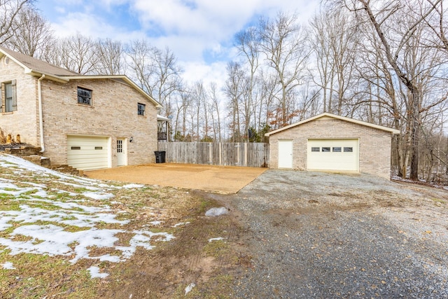 snow covered property featuring a garage