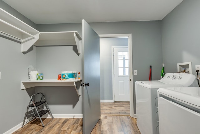 laundry room featuring washing machine and dryer and wood-type flooring