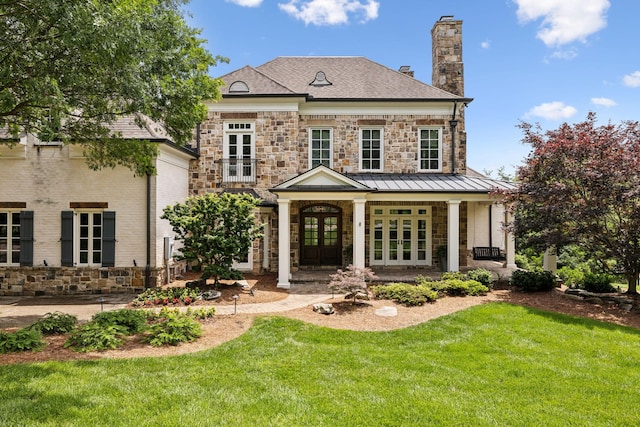 view of front facade featuring a front lawn and french doors