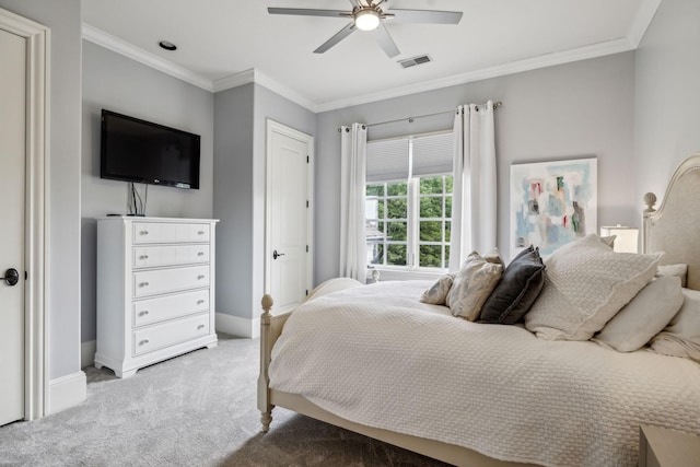 carpeted bedroom featuring ceiling fan and ornamental molding