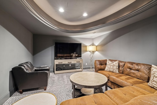 carpeted living room featuring a raised ceiling