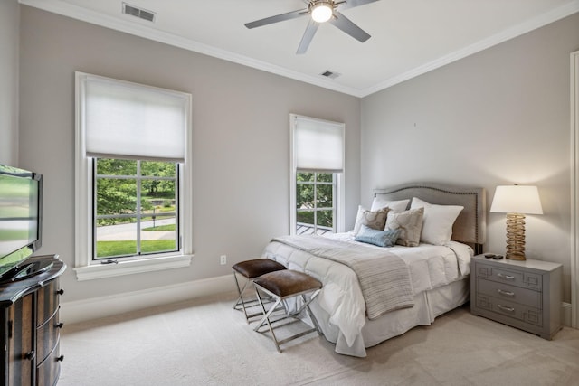 bedroom with ceiling fan, ornamental molding, light carpet, and multiple windows