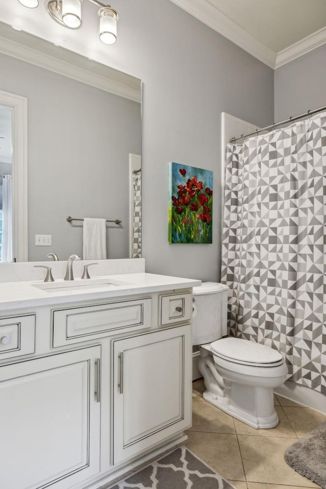 bathroom with tile patterned floors, toilet, crown molding, and vanity