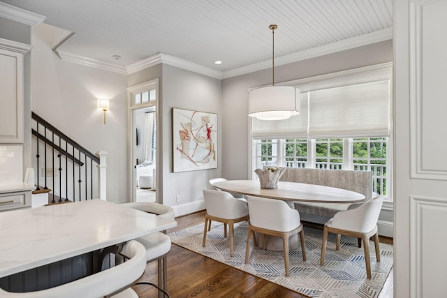 dining area with breakfast area, crown molding, and dark hardwood / wood-style floors