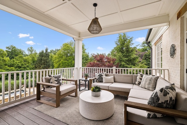 wooden terrace with an outdoor living space