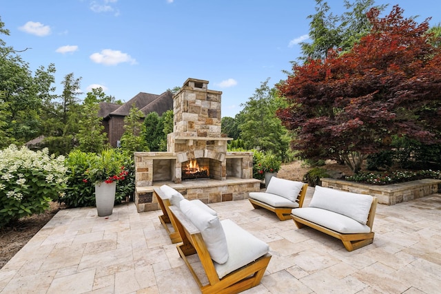 view of patio / terrace featuring an outdoor stone fireplace