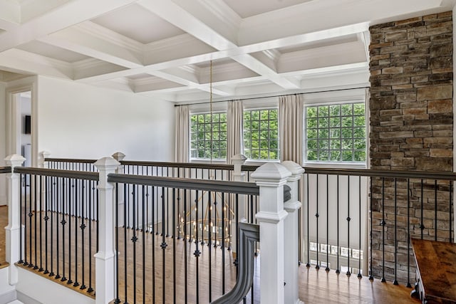 hallway featuring hardwood / wood-style flooring, crown molding, beamed ceiling, and coffered ceiling