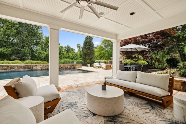 view of patio featuring ceiling fan, pool water feature, and an outdoor hangout area