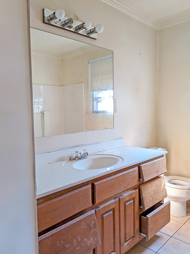 bathroom featuring tile patterned floors, vanity, crown molding, and toilet
