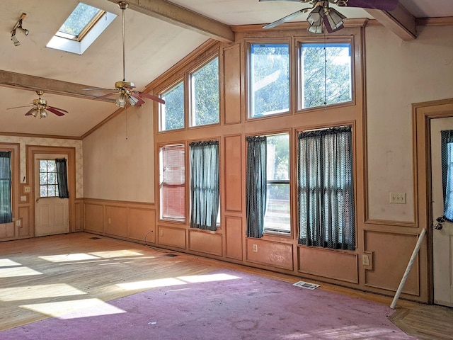 interior space featuring beamed ceiling, high vaulted ceiling, and ceiling fan