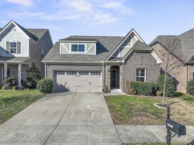 view of front of property with a garage and a front lawn