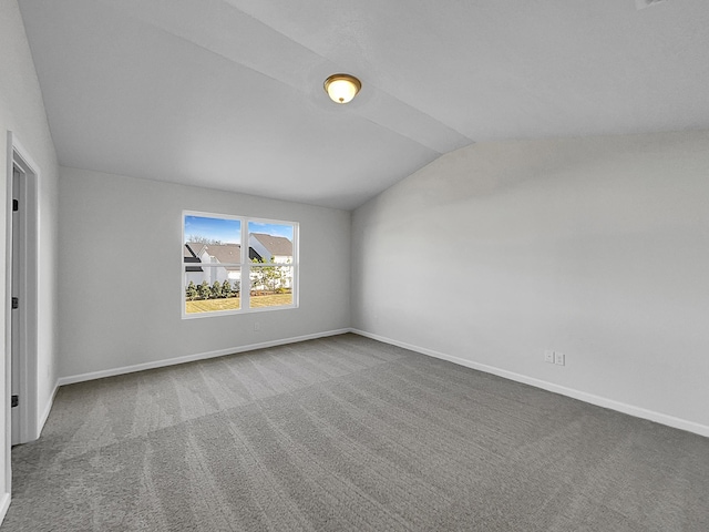 empty room featuring carpet floors and lofted ceiling